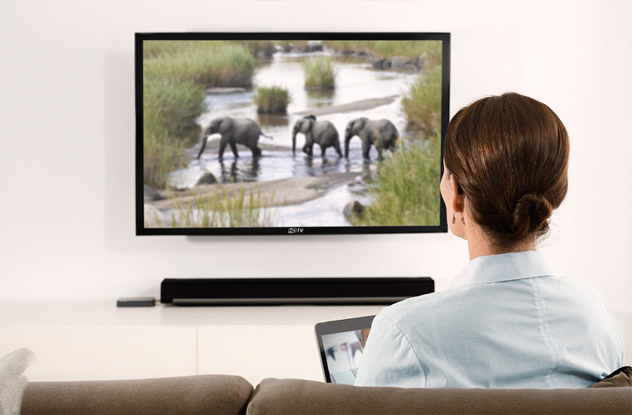 woman watching tv with hearing aids