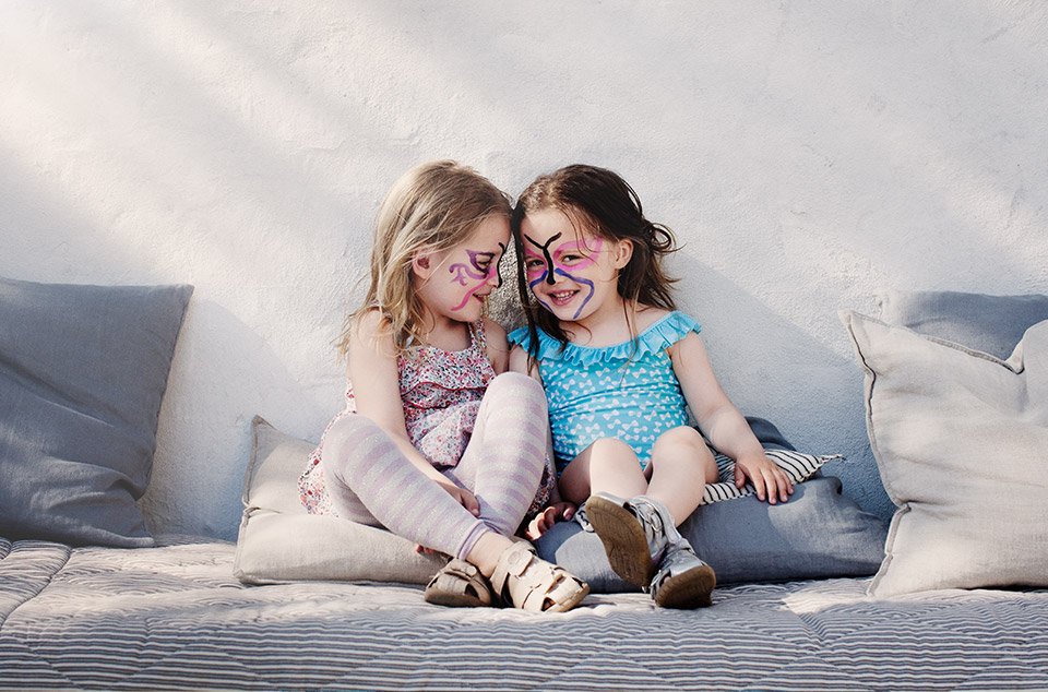 Two pre-school aged girls laughing 