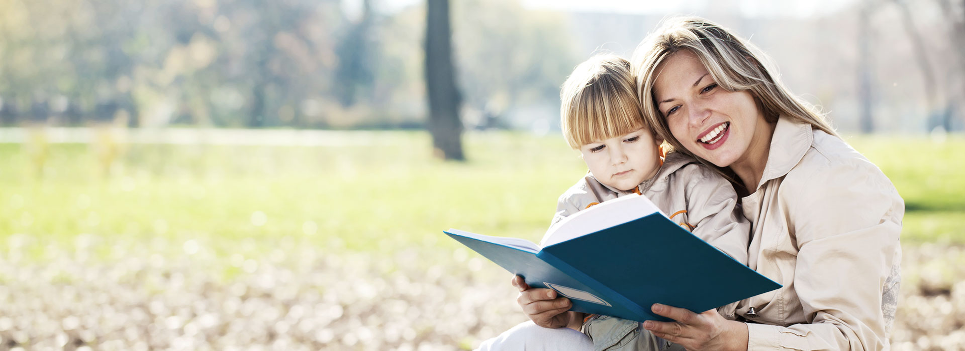 woman reading book to girl