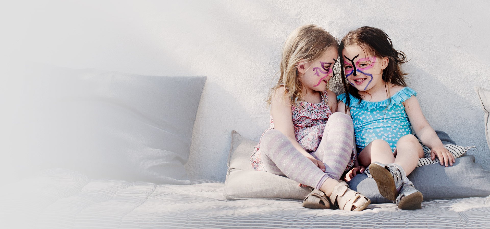 Two pre-school aged girls laughing 