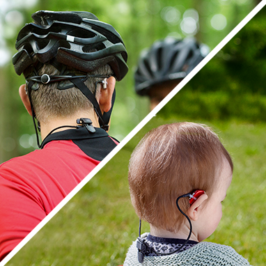 Man and child wearing hearing aid retention cord